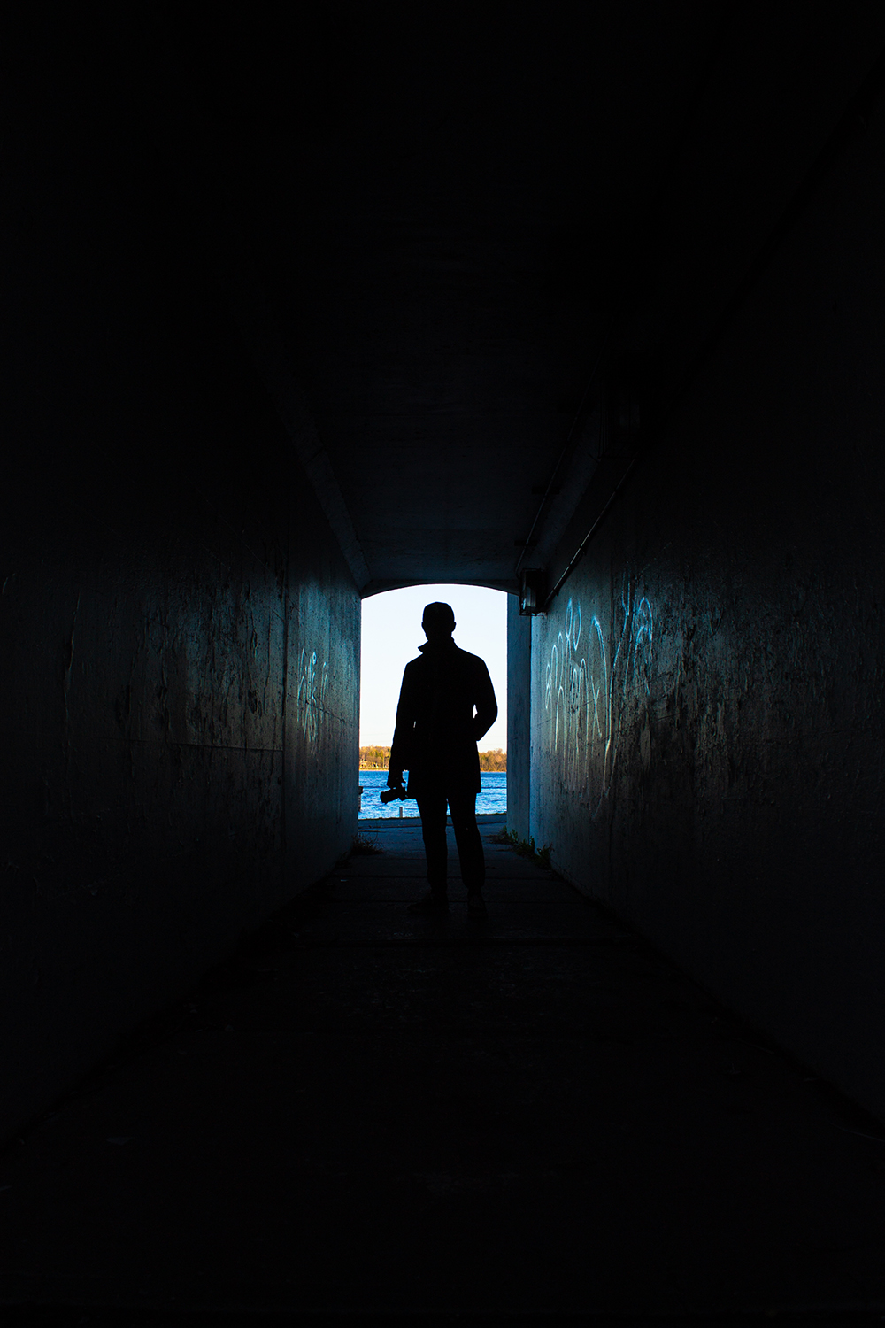 Silhouette of photographer in tunnel